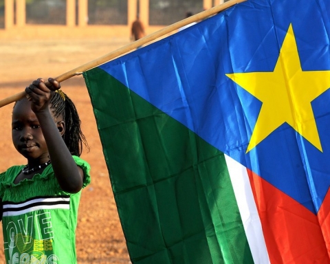 A young girl hangs the South Sudan flag