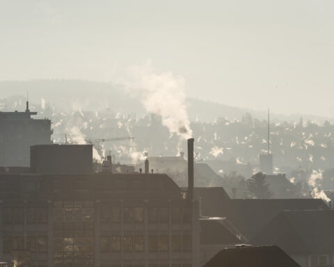 Smoke rises from chimneys, pictured from a balcony on Im Sydefaedeli Street in Zurich, Switzerland, on February 14, 2019. (KEYSTONE / Christian Beutler)